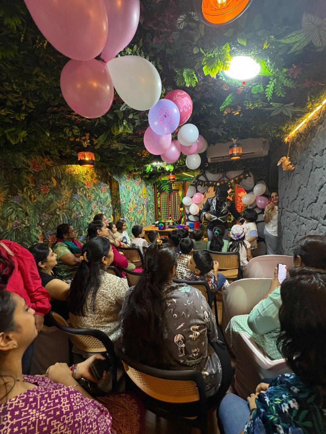 Parents in the cafe with a magic show at a Wild Wonders birthday party