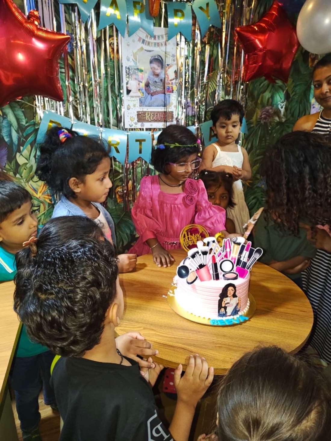 Cake-cutting moment coordinated by staff at a Wild Wonders birthday party